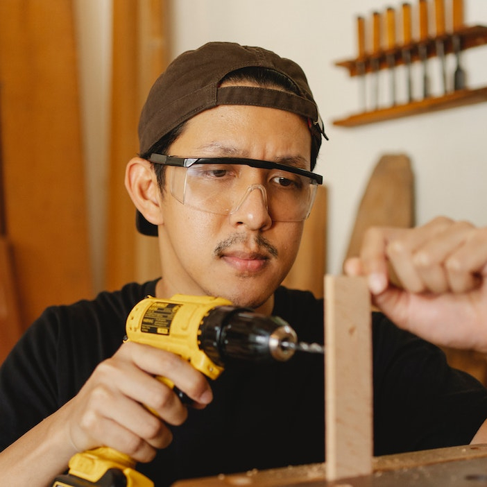 image of Xavier with safety googles working on project