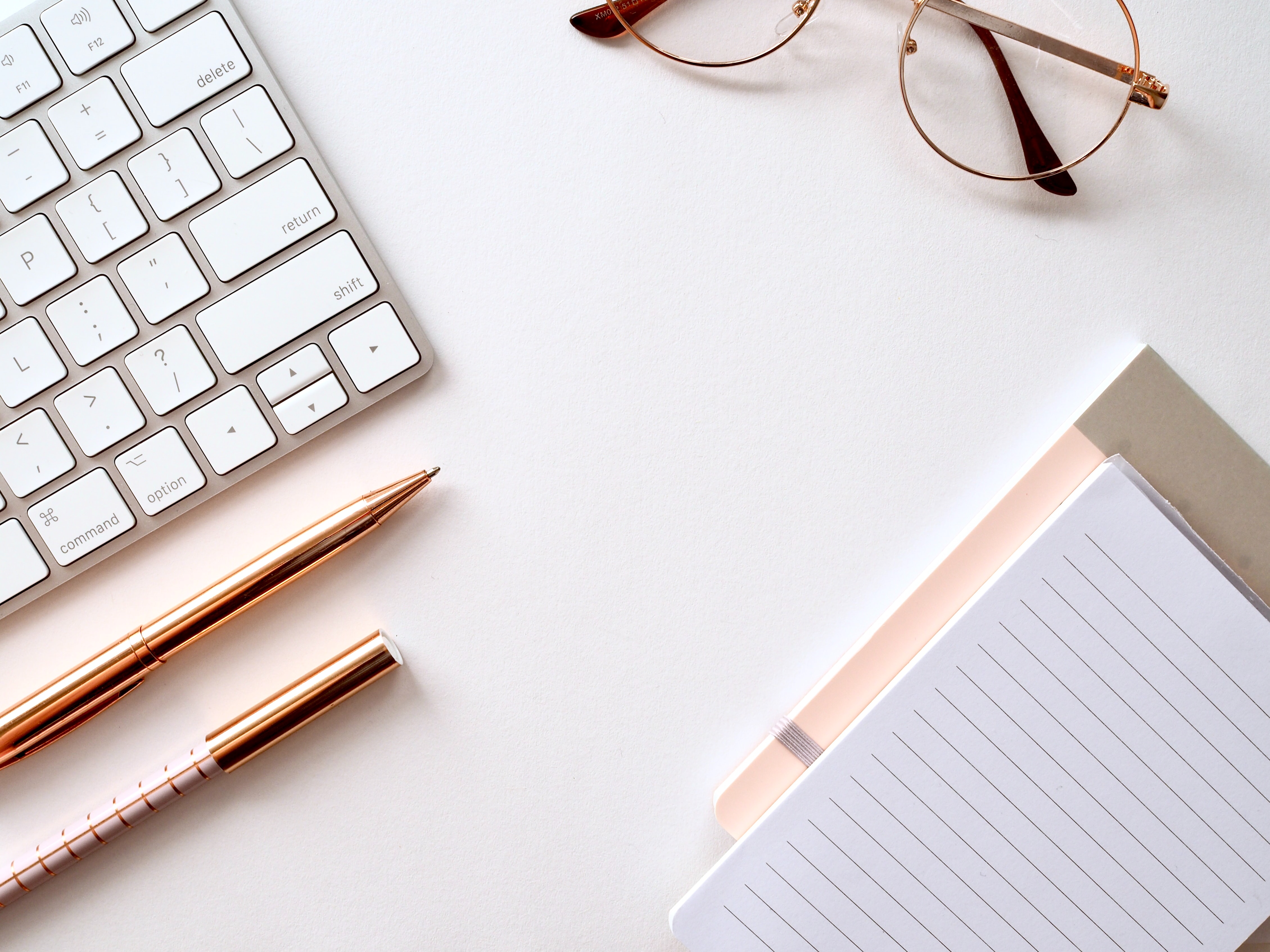 work surface with notepads,pencils, and keyboard